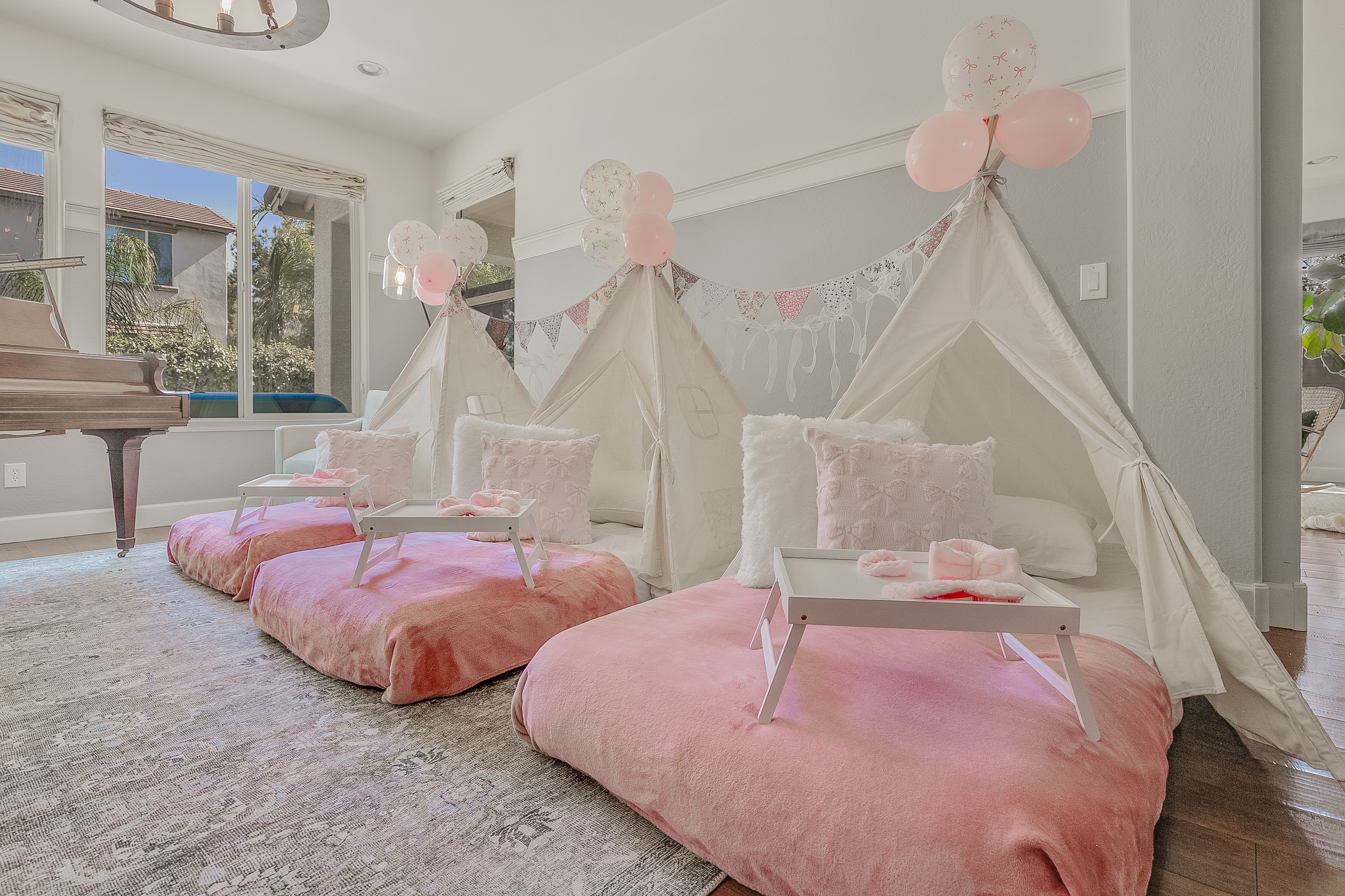 Valley Sleepovers tent setup with pastel decor and fairy lights